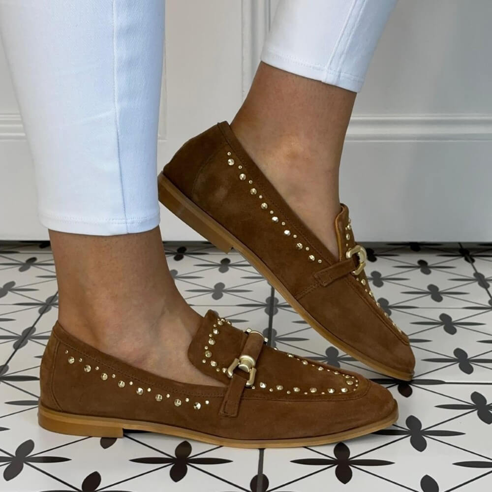 MJUS Tan Suede Loafers with studs worn on a tiled floor