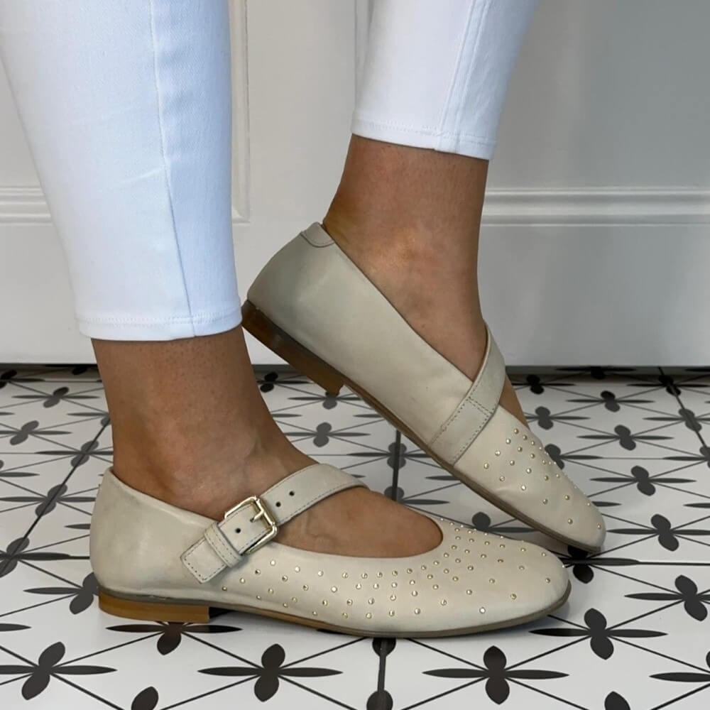 MJUS Beige Mary-jane flat shoes with a strap worn by a person on a patterned floor.