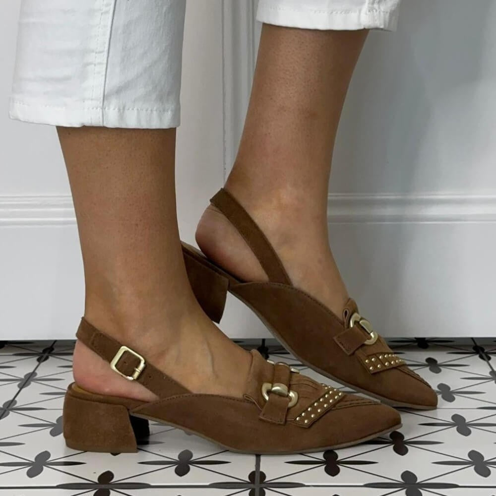 MJUS Brown suede Loafer shoes with gold buckles worn by a person on a patterned floor.
