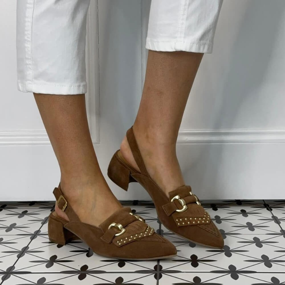 MJUS Brown suede Loafer shoes with gold buckles worn by a person on a patterned floor.