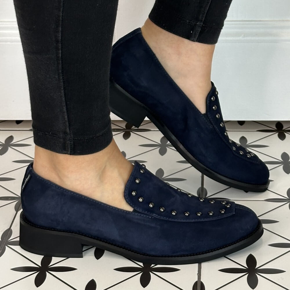 Navy blue loafers with studded details worn indoors on a patterned floor.  Marco Moreo Suede Loafer 