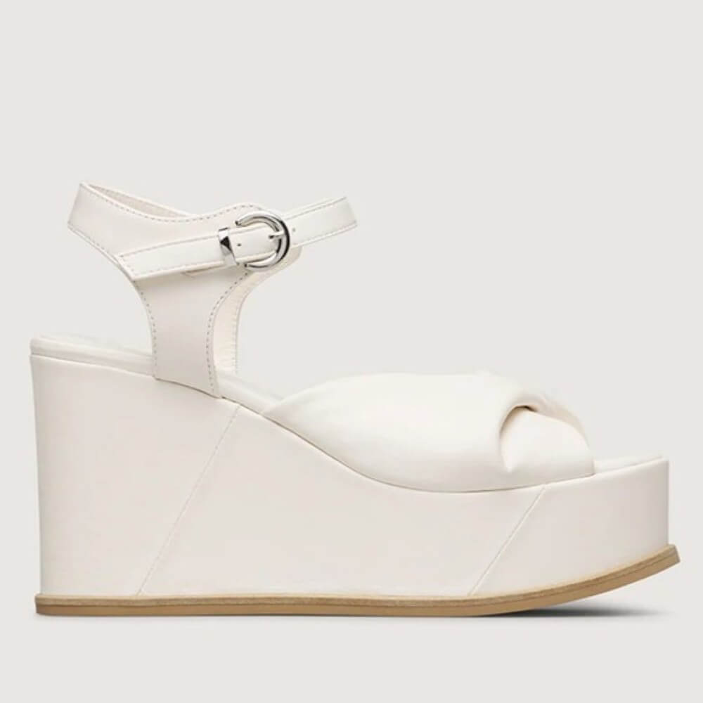 Marco Moreo White wedge sandal with a platform sole on a light gray background