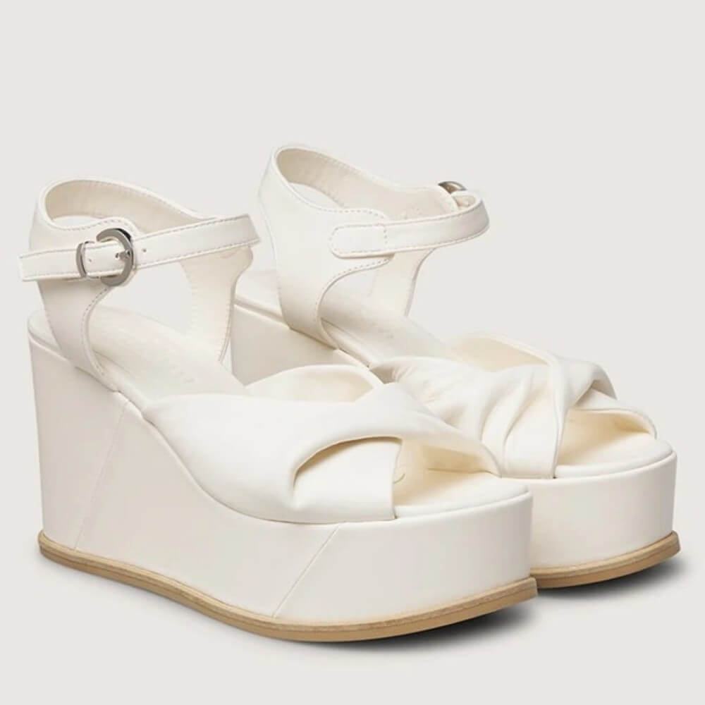 Marco Moreo White wedge sandals with a platform sole on a light gray background