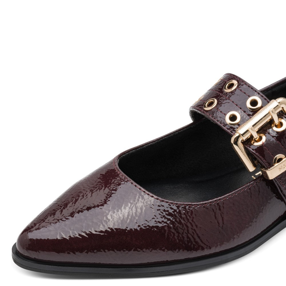 Marco Tozzi wine patent leather shoe with gold buckle on a white background