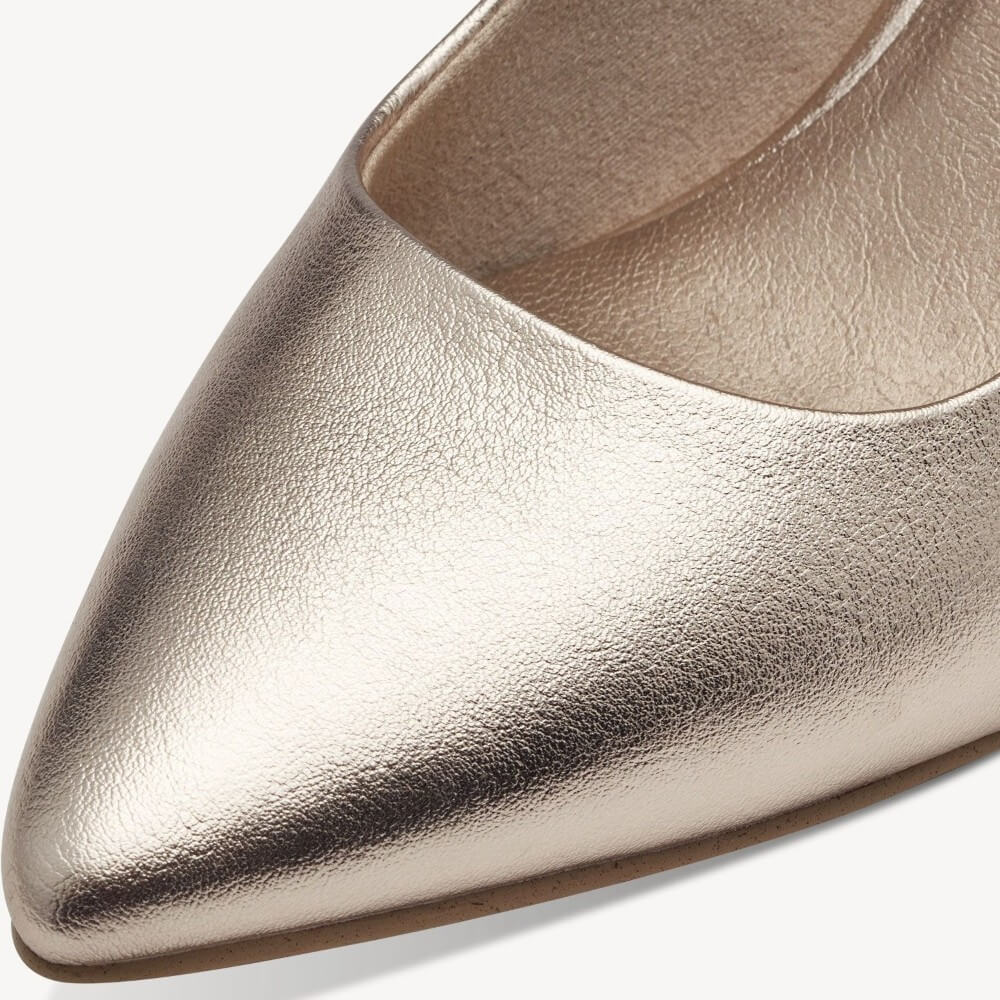 Close-up of a metallic gold pointed-toe shoe on a white background