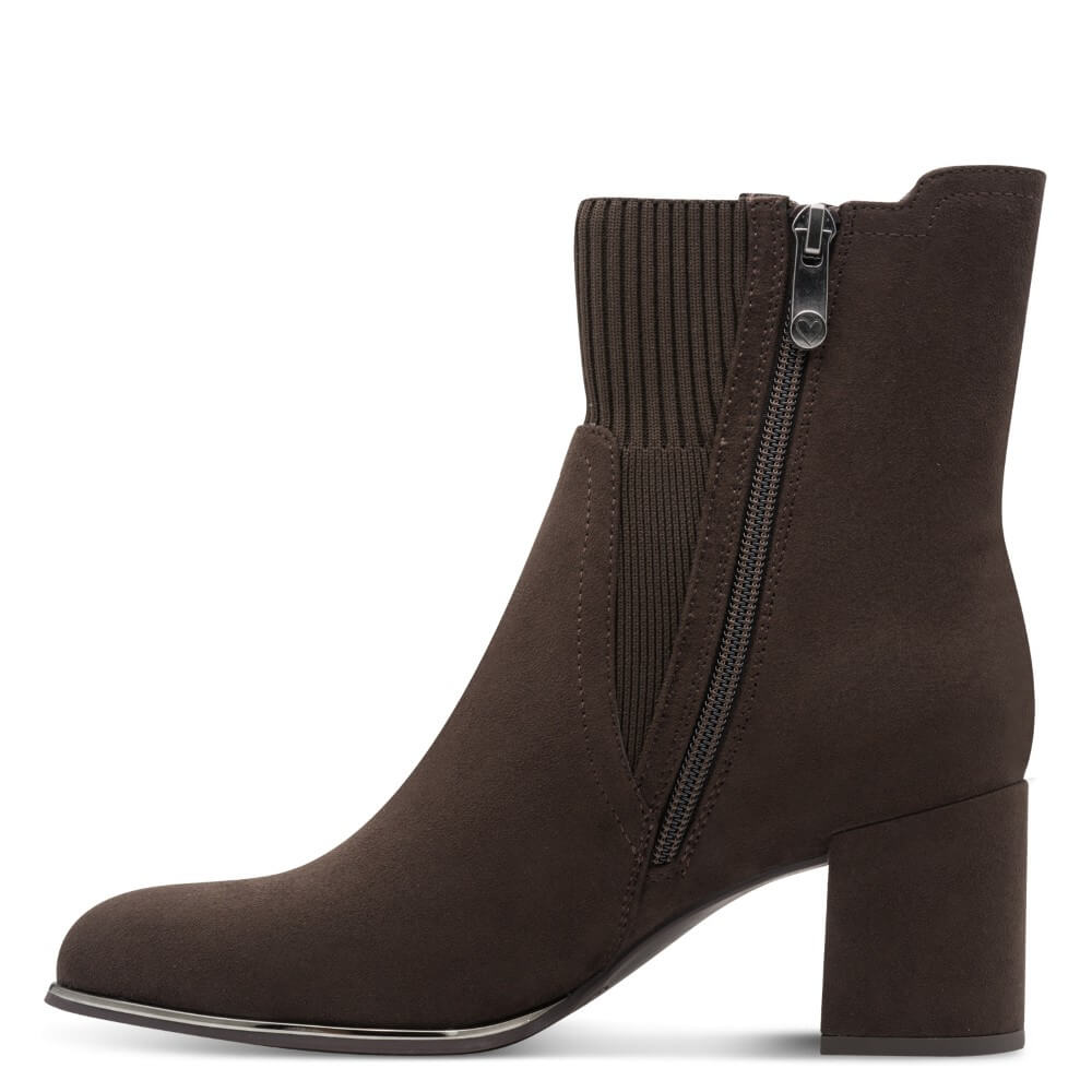 A Marco Tozzi  dark brown Vegan suede ankle boot with a ribbed knit side panel and a side zipper, shown from a side profile view on a white background.