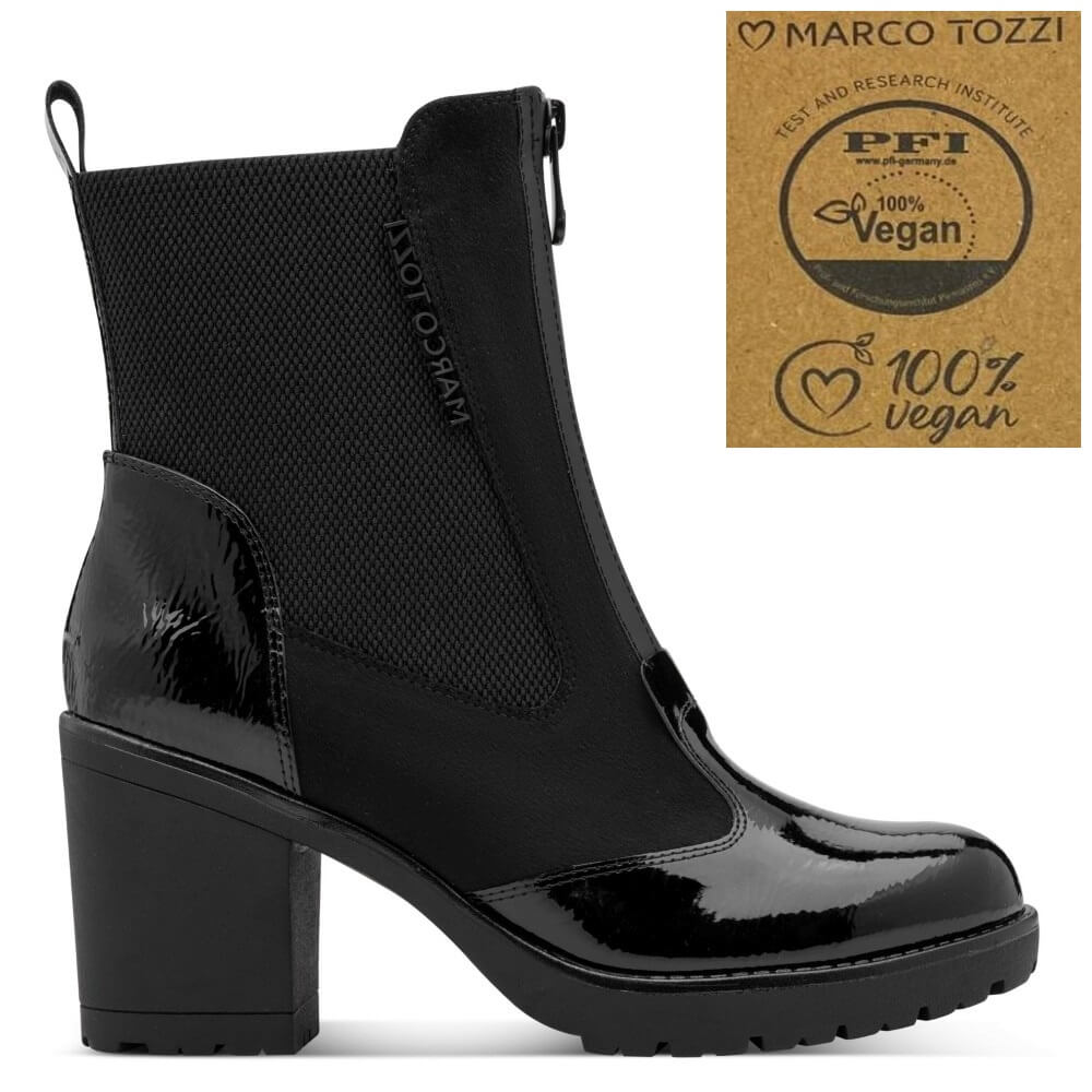 A black ankle boot with a glossy patent leather toe and block heel, shown in profile on a white background. A brown cardboard-style badge in the top right reads 'Marco Tozzi' and 'PFI 100% Vegan'.