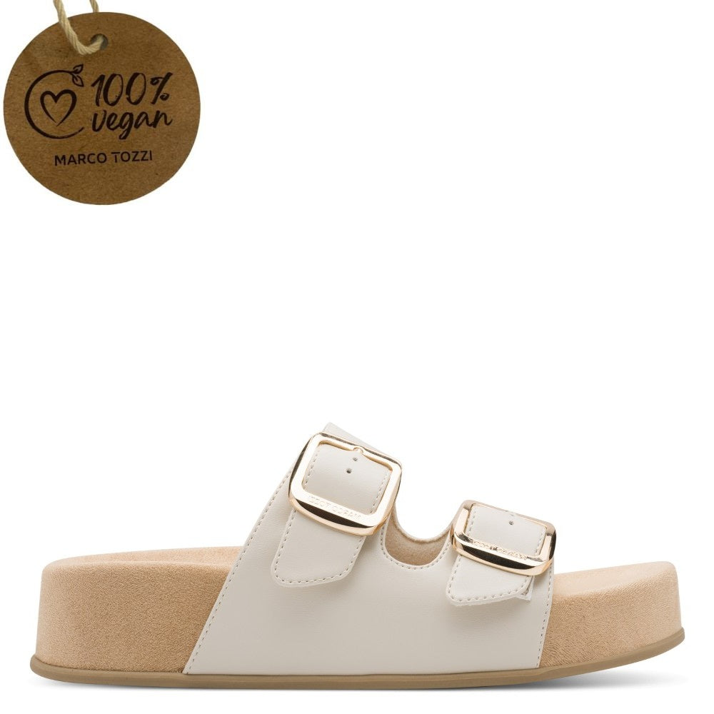 Marco Tozzi cream White sandal with gold buckles on a white background, featuring a '100% vegan' tag.