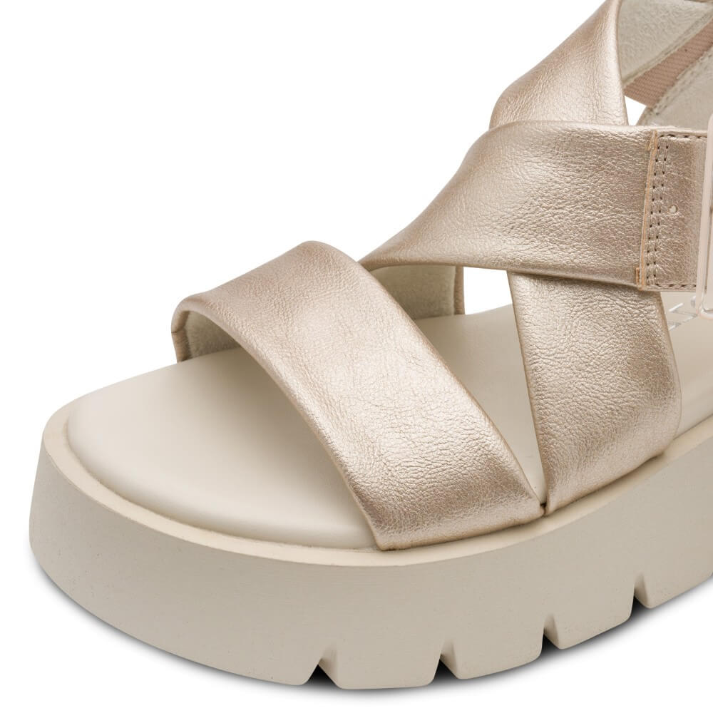 Marco Tozzi Gold sandal with platform sole on a white background,  