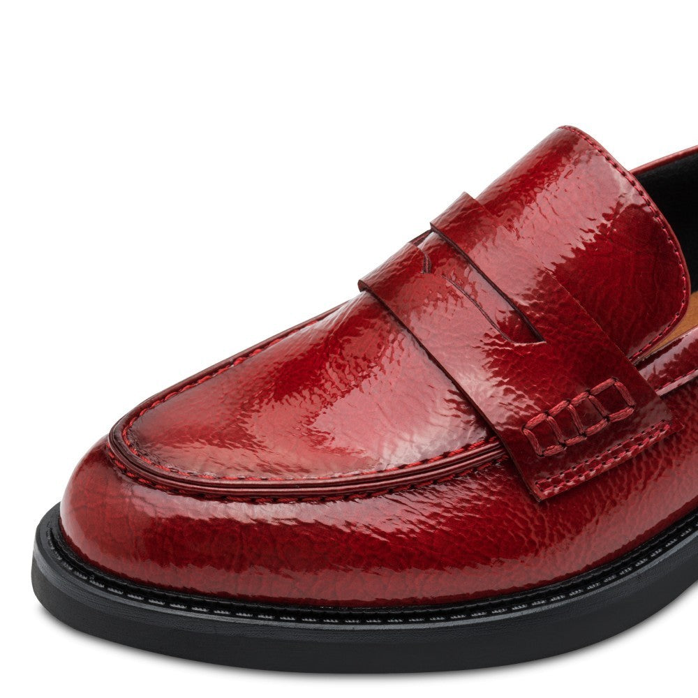 Red loafer shoe with a '100% Vegan' label by Marco Tozzi on a white background Marco Tozzi Patent Vegan Loafer 2-24308