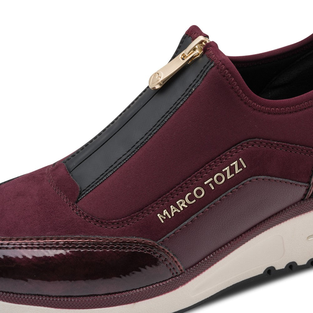 Maroon slip-on shoe with gold zipper and 'Marco Tozzi' branding on a white background