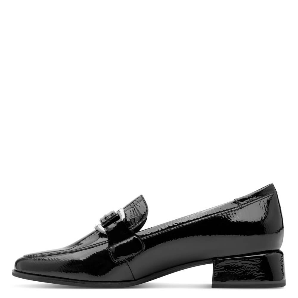 Black patent leather loafer on a white background