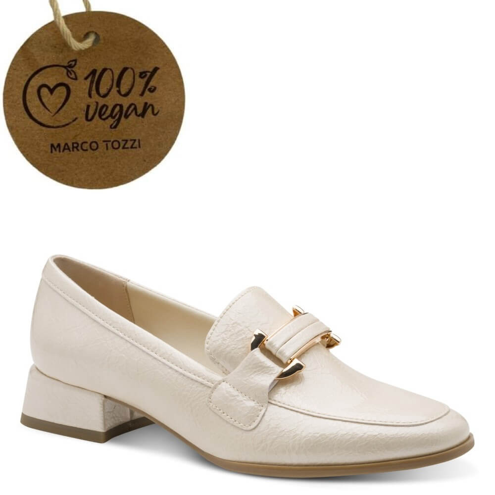 cream loafer shoe with gold buckle detail and a '100% Vegan' label on a white background