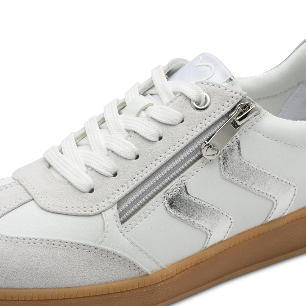 White sneaker with silver stripes and a brown sole and '100% Vegan' label on a white background