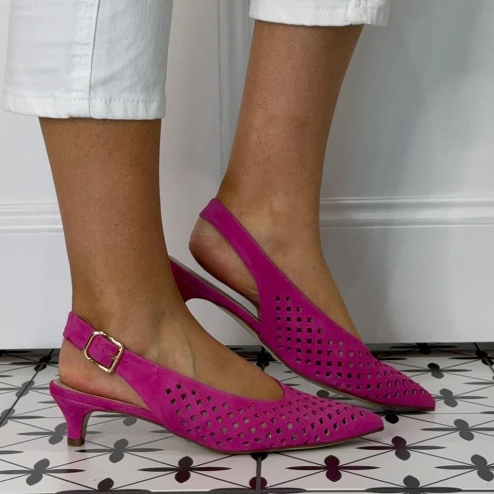 Marian Pink kitten-heeled shoes with a gold buckle on a patterned floor.