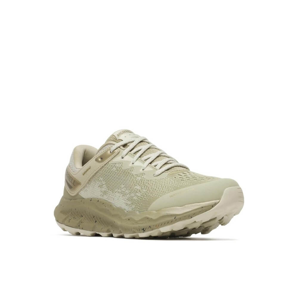 A  Merrell waterproof running shoe in a light green and beige colourway, featuring a textured knit upper, a speckled white midsole, and a light grey outsole, shown against a plain white background.