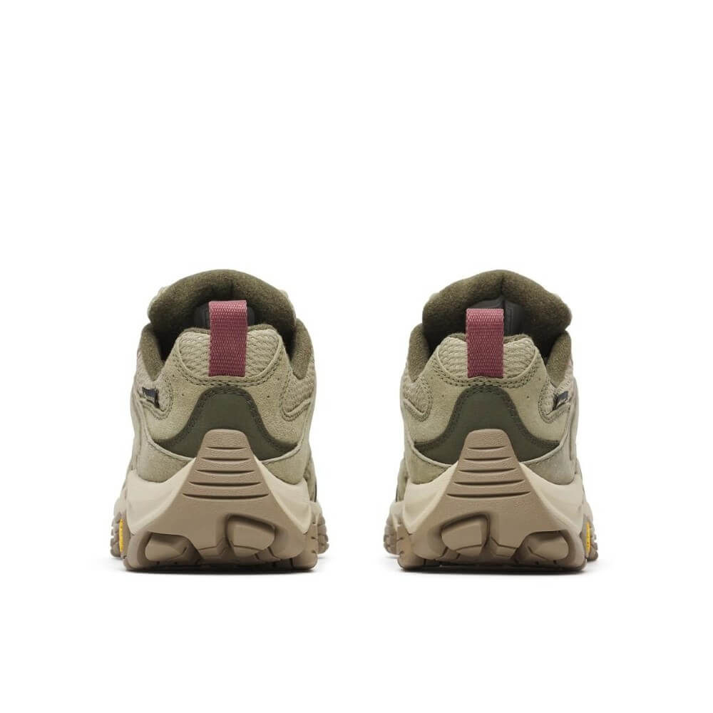 A pair of Merrell hiking shoes in olive green and beige with light pink accents, shown in profile against a white background. 