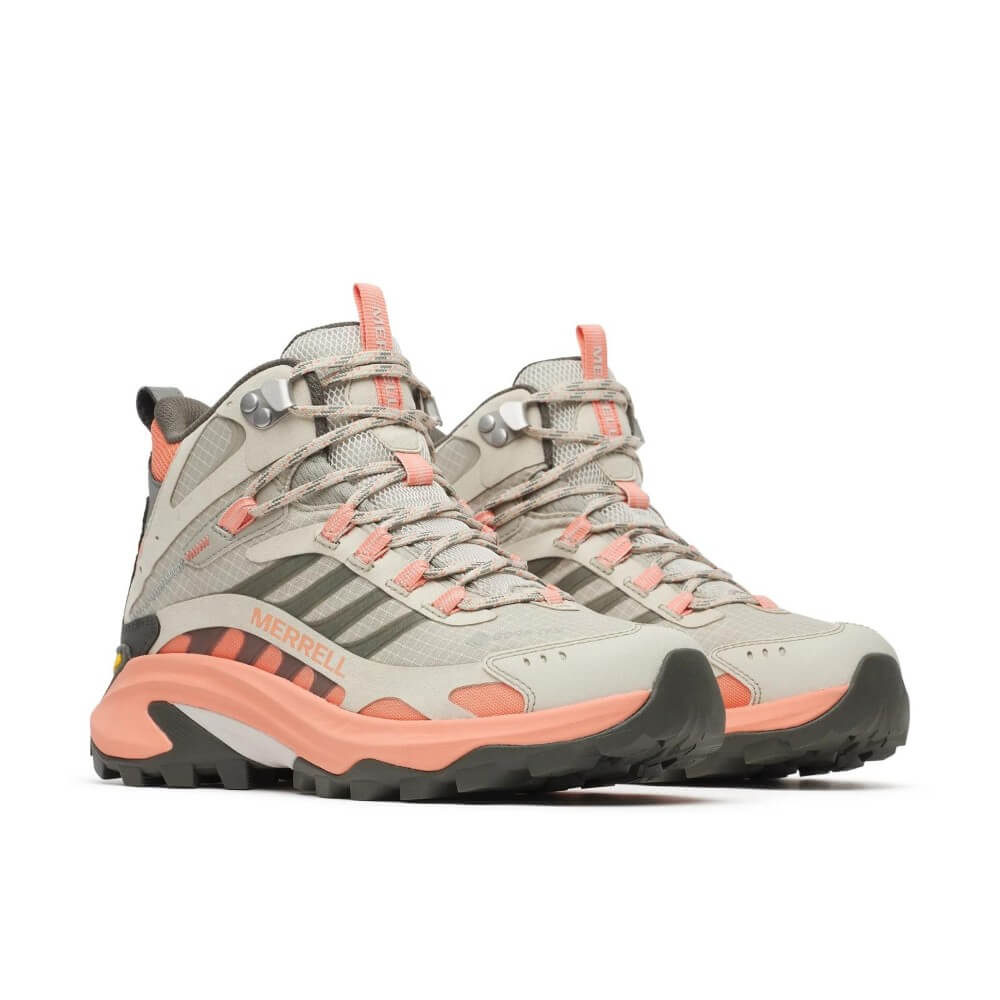 A pair of Merrell mid-height hiking boots in light grey and coral pink, featuring a  Vibram sole, shown from a side profile on a white background.