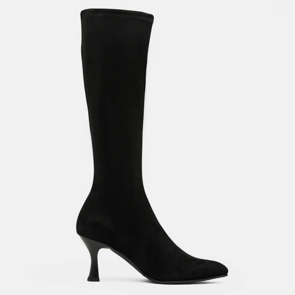 A Miss Elastic black suede knee-high boot with a pointed toe and a slim kitten heel, shown in profile against a light grey background.