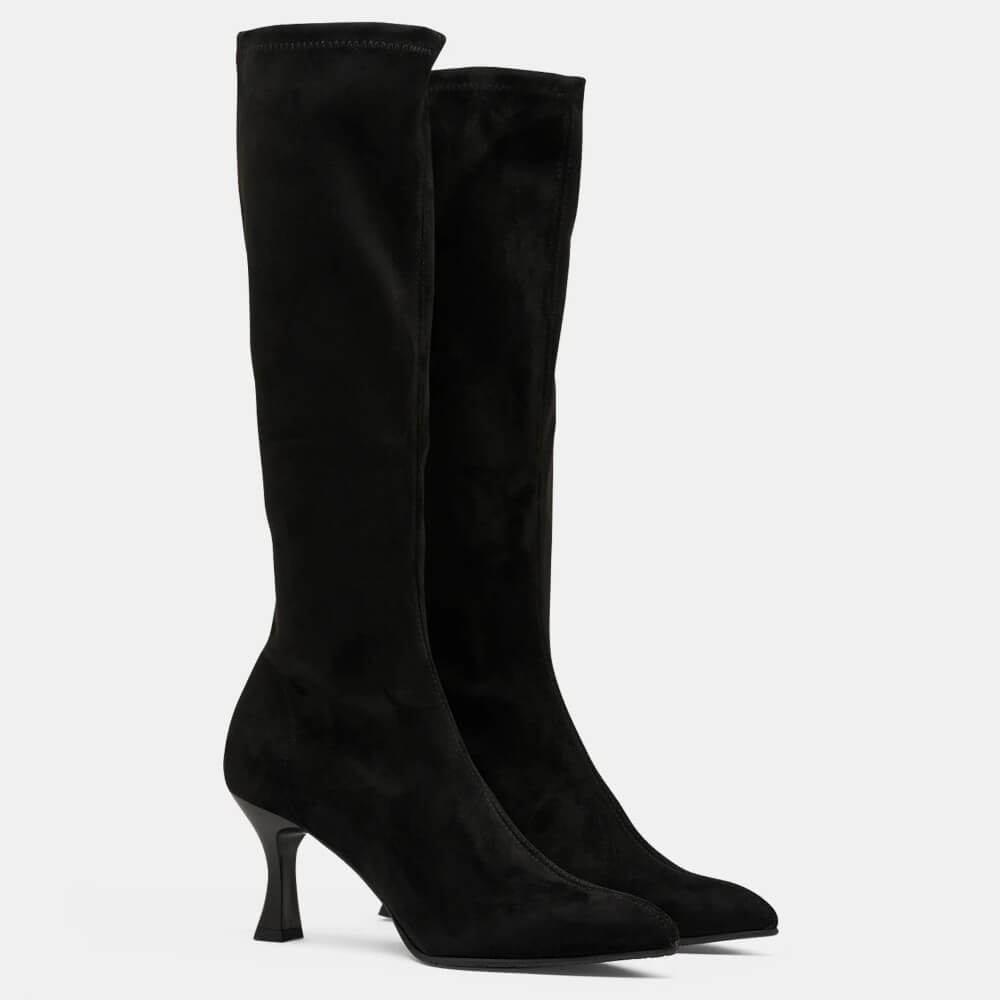 A pair of Miss Elastic black suede knee high boots with pointed toes and slim high heels, shown against a plain light grey background.
