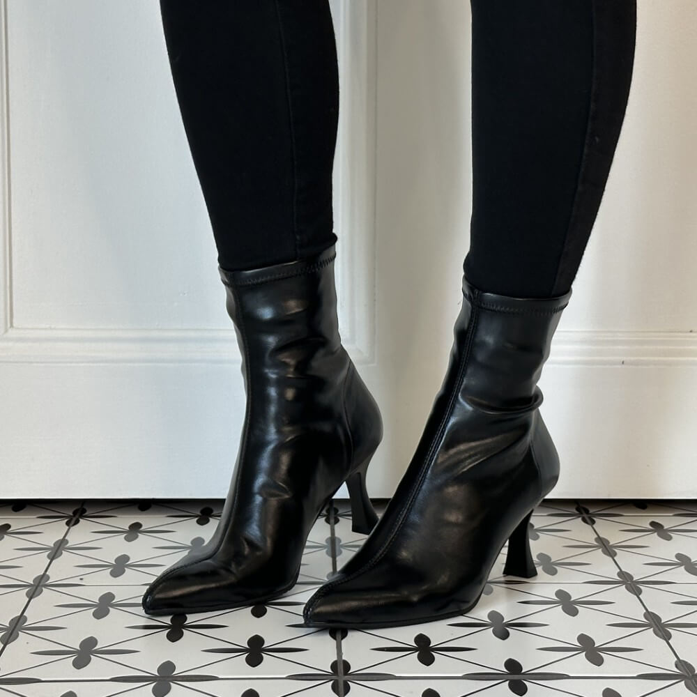 Miss Elastic Black Stretch ankle boots with kitten heels, worn with black leggings on a patterned black and white tile floor.