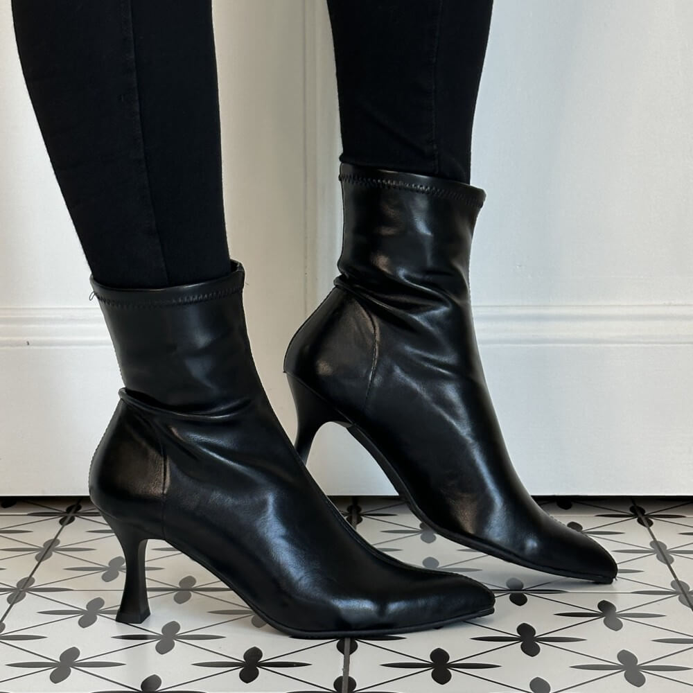 Miss Elastic Black Stretch ankle boots with kitten heels, worn with black leggings on a patterned black and white tile floor.