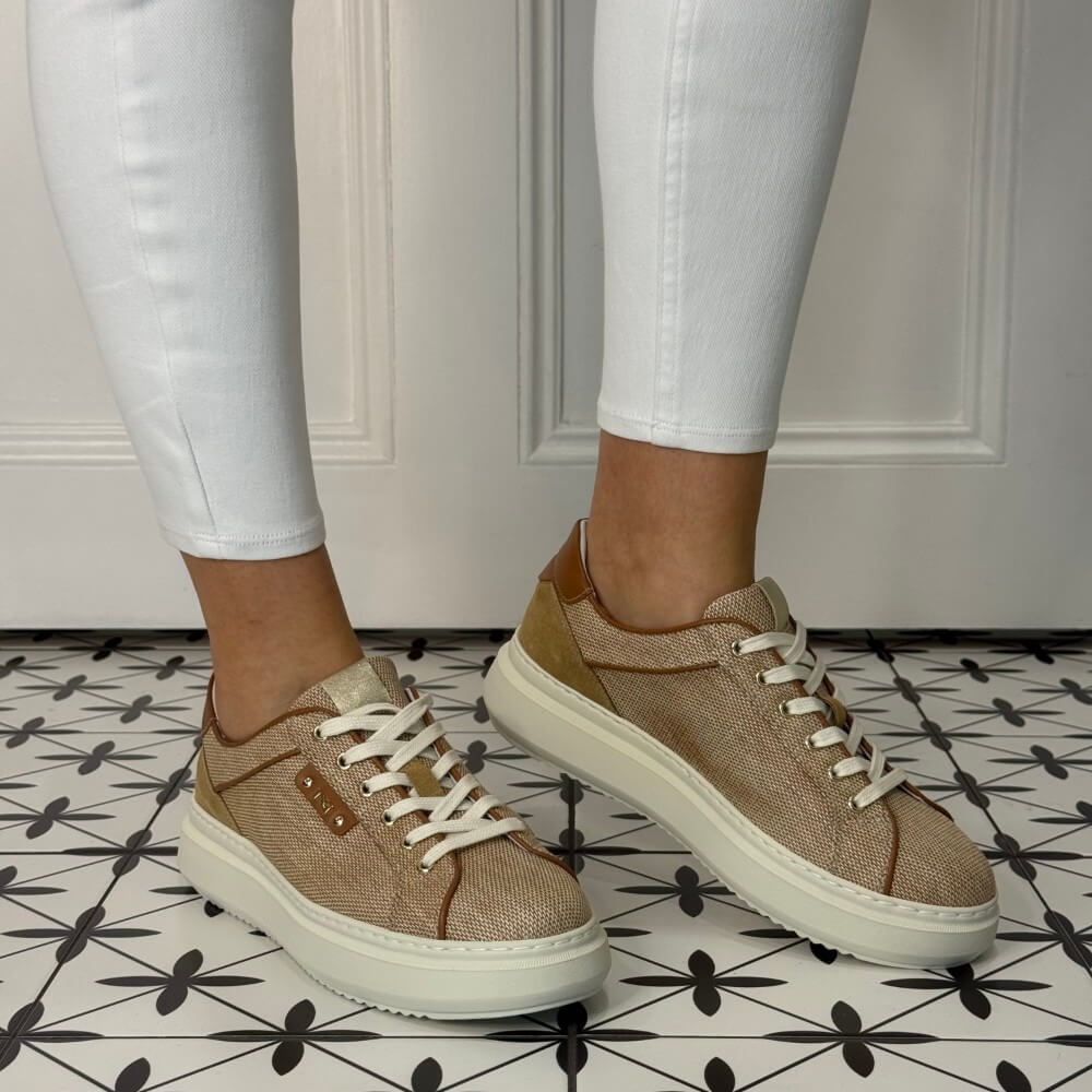 Brown sneakers worn with white pants on a patterned floor. NeroGiardini E615282D