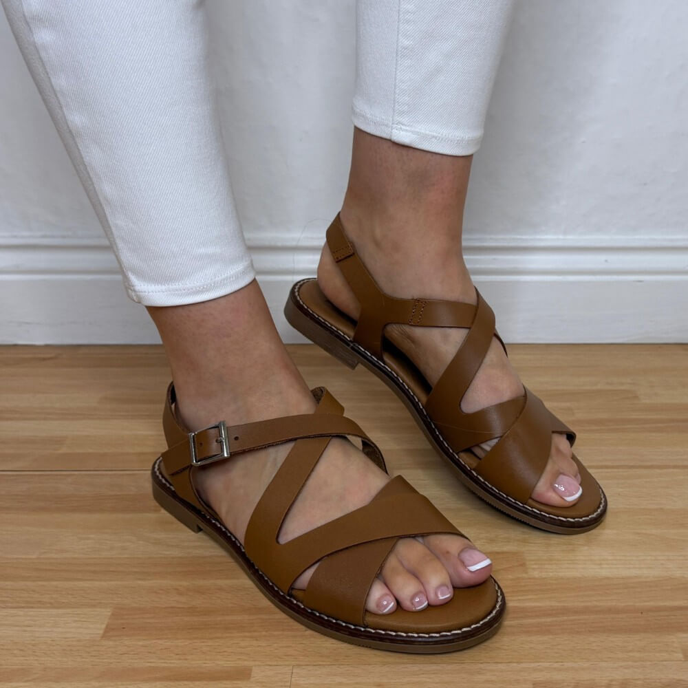 OH My Sandals 5832 Tan Leather sandals worn with white pants on a wooden floor.
