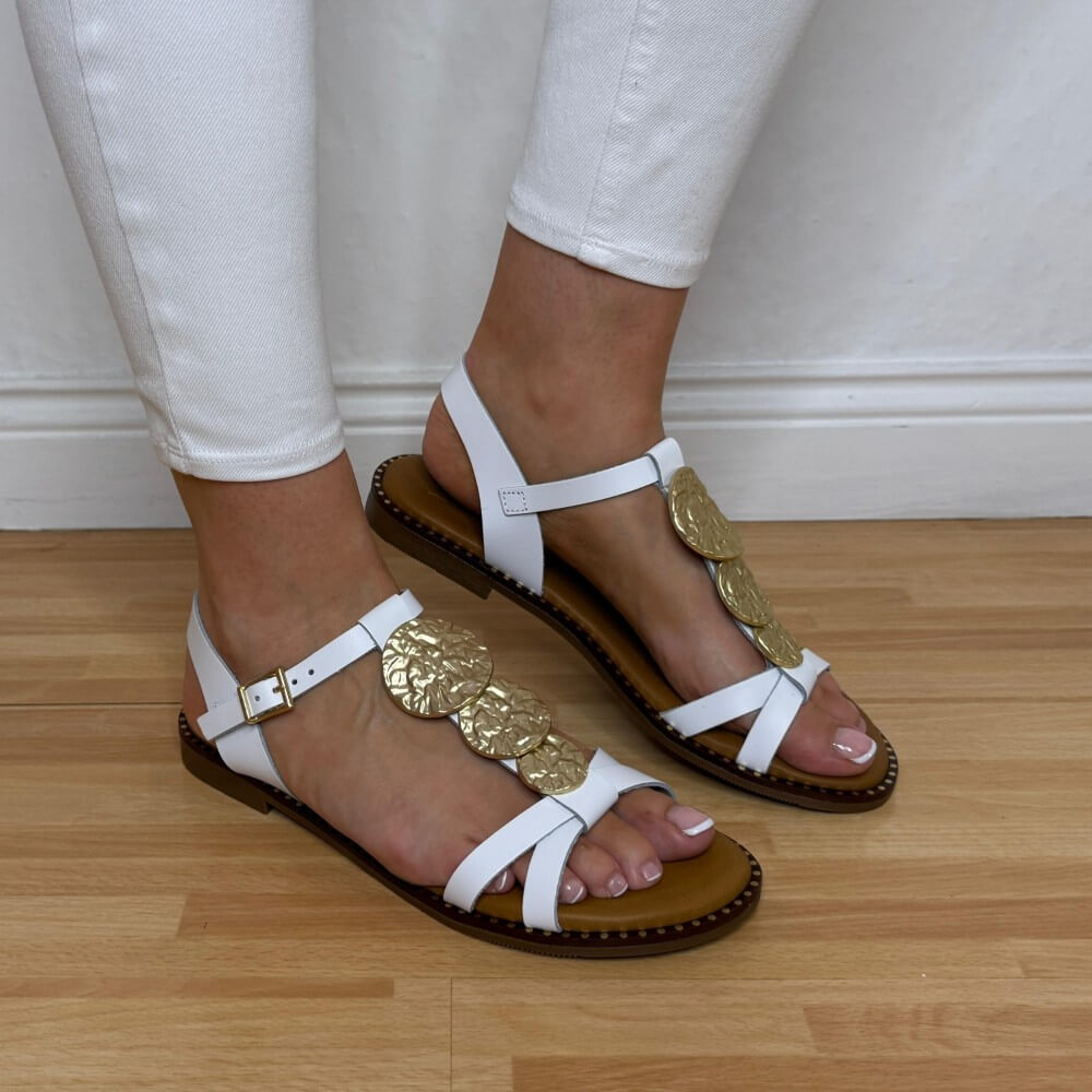 Oh My Sandals 5849 White sandals with gold embellishments worn on a wooden floor.