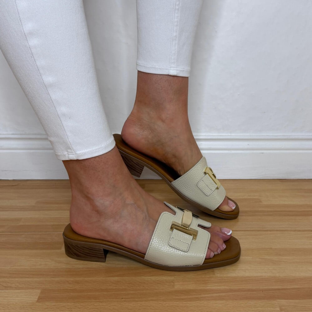 Oh My Sandals 5890 Beige sandals with brown soles worn by a person on a wooden floor.