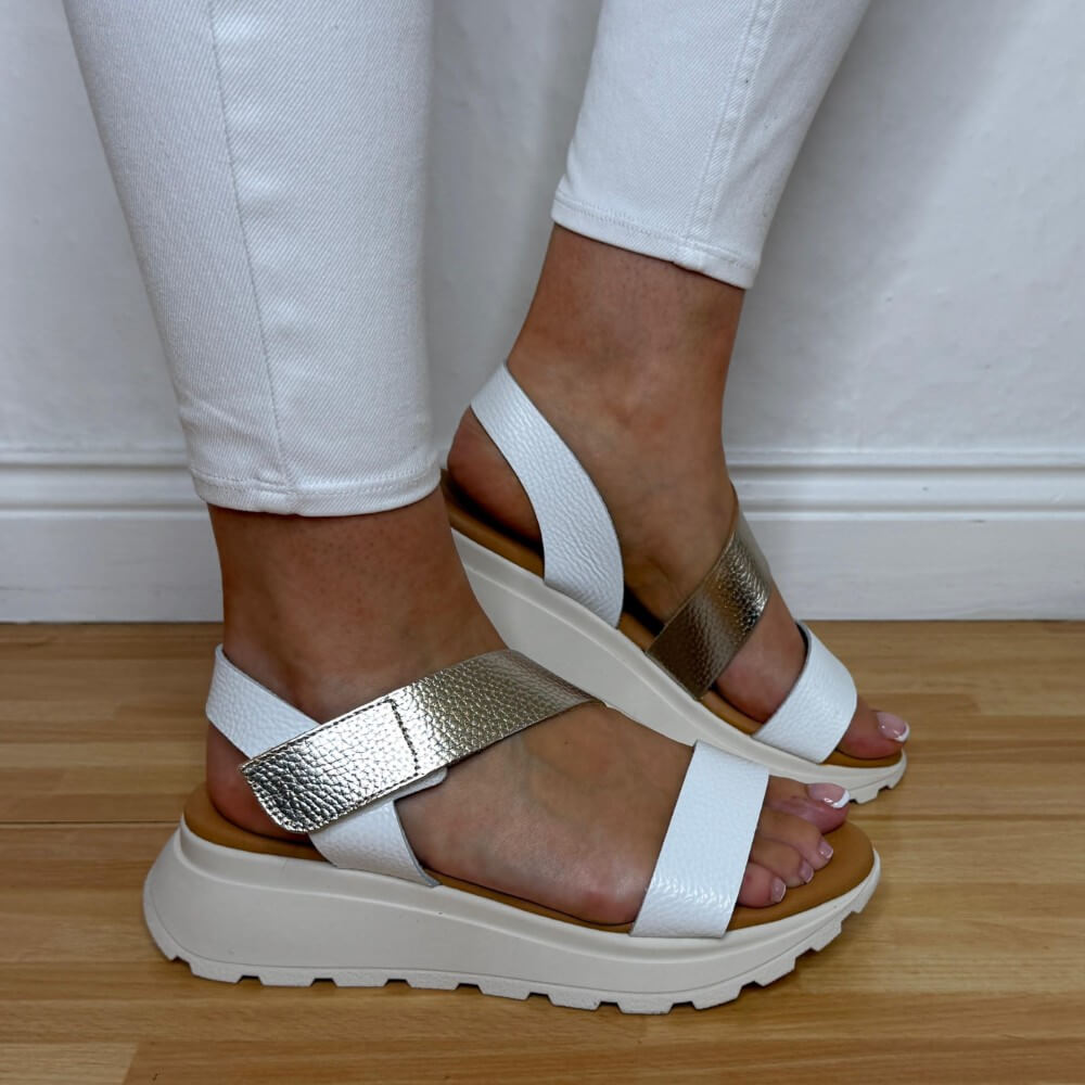 Oh My Sandals 5951 White sandals with gold straps worn by a person on a wooden floor.