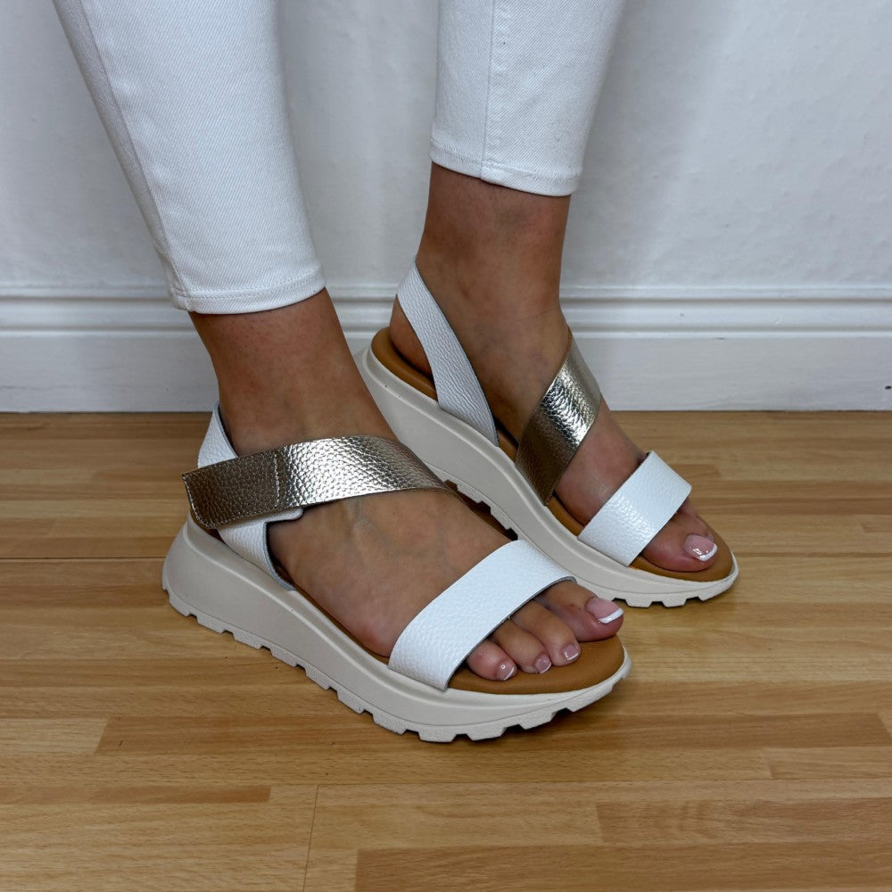 Oh My Sandals 5951 White sandals with gold straps worn by a person on a wooden floor.