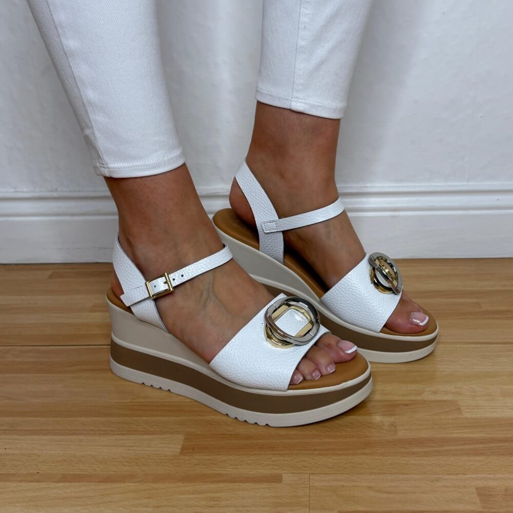 Oh My Sandals 5984 White platform sandals with gold buckles worn by a person on a wooden floor