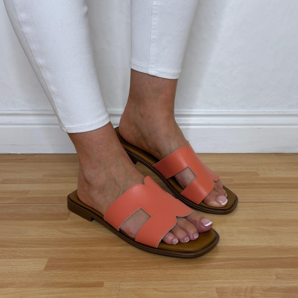 Person wearing Oh My Sandals 5580 orange sandals on a wooden floor