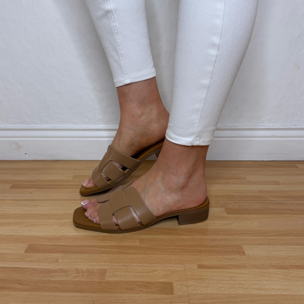 Oh My Sandals 5880 Taupe Brown sandals worn with white pants on a wooden floor.