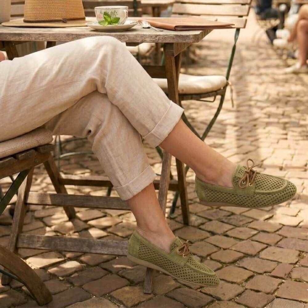 Person wearing Paul Green 1218 Green Suede Moccasins in a cobbled street