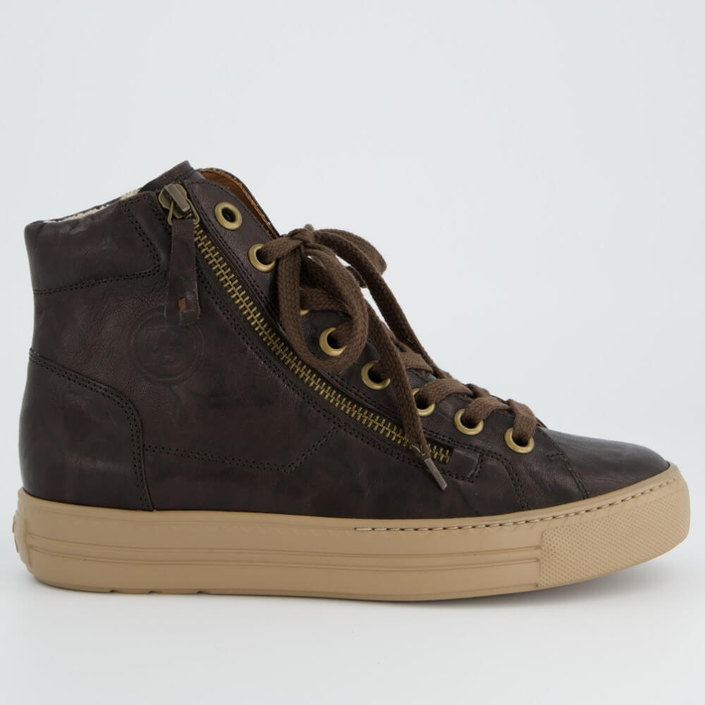 A Paul Green dark brown distressed leather high-top sneaker with a tan rubber sole, brown laces, and a side zipper with brass eyelets, shown from a side profile on a light grey background.