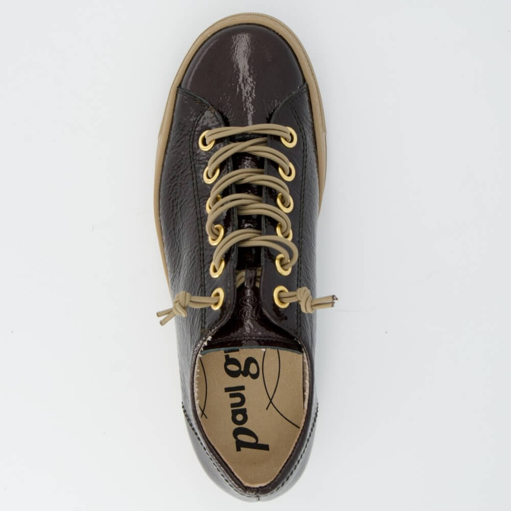 A Paul Green low-top sneaker in glossy dark brown textured leather with beige laces threaded through gold-tone eyelets and a thick beige rubber sole, shown on a light grey background.