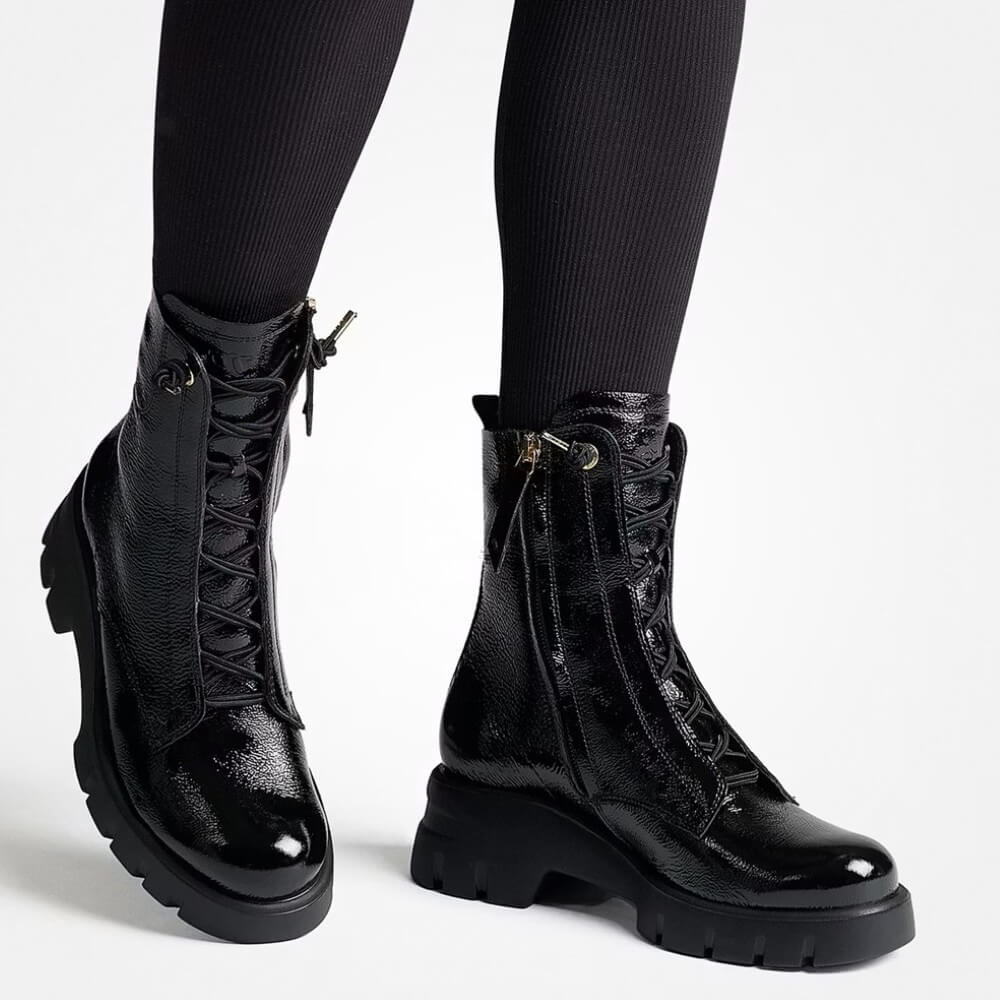 Black patent leather lace-up boots worn with black tights on a white background Paul Green 8216 Lace up Ankle Boot-Black Patent Leather