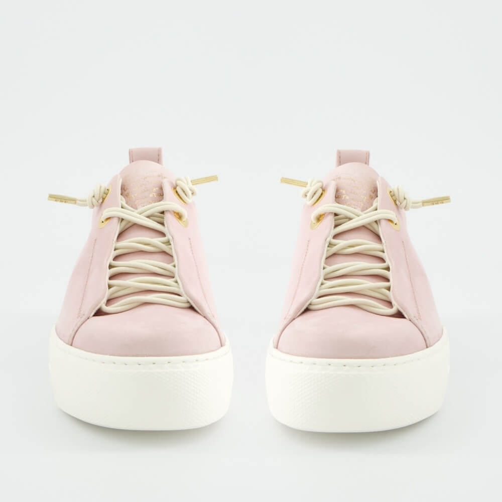 Pair of pink  sneakers with white soles on a light gray background