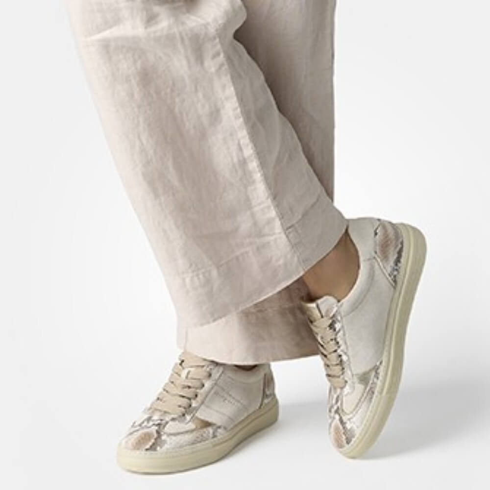 Paul Green 5466 Beige and snake sneakers worn with light-coloured pants on a white background