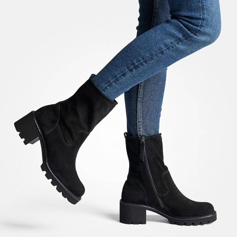 Black ankle boots worn with blue jeans on a white background Paul Green Black Suede Block Heel Ankle Boots 8133