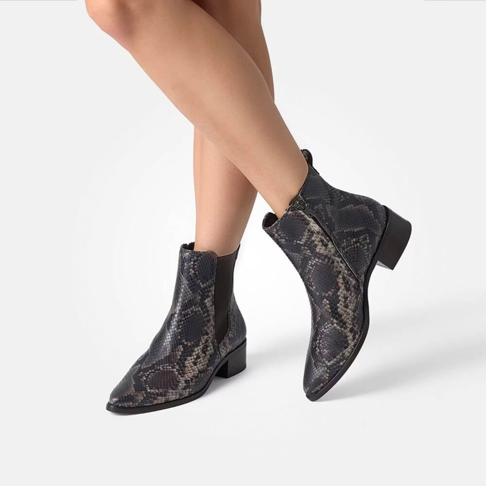 Snake print ankle boots worn by a person on a white background  Paul Green Chelsea ankle boots 8271 