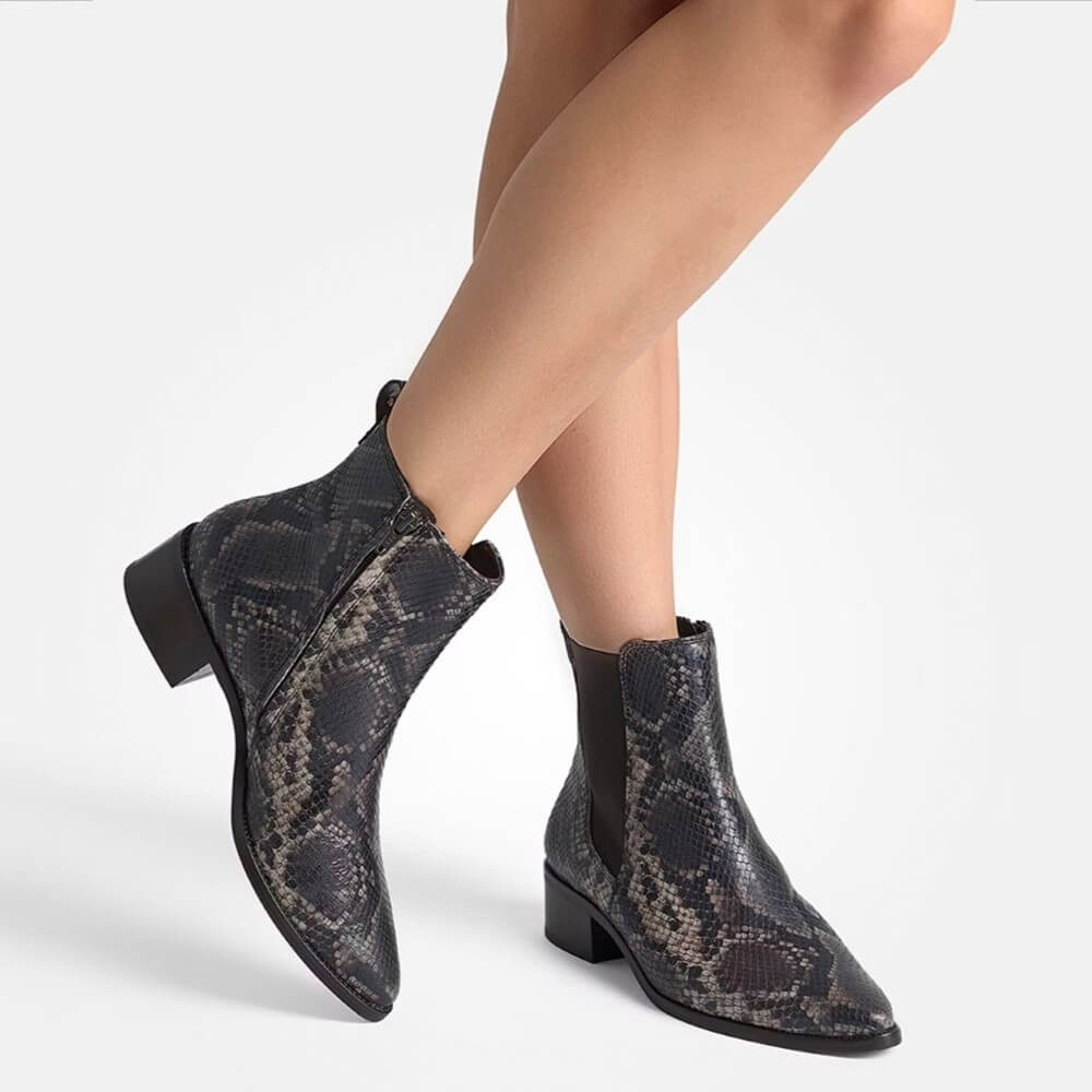 Snake print ankle boots worn by a person on a white background  Paul Green Chelsea ankle boots 8271 