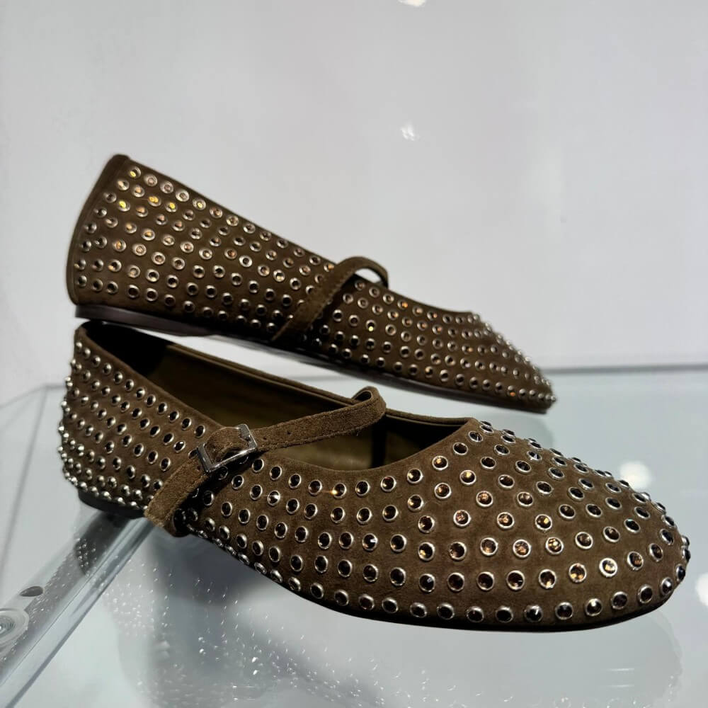 A pair of Pedro Anton Khaki Green flat shoes decorated with silver-tone metal studs and a matching Khaki strap with a silver buckle, shown against a plain white background.
