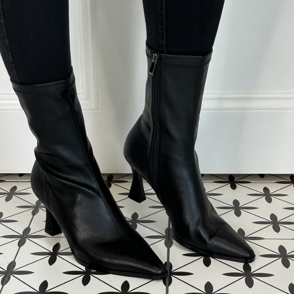 Black high-heeled boots on a patterned floor Pedro Anton Cork Heel Sock Boot Black