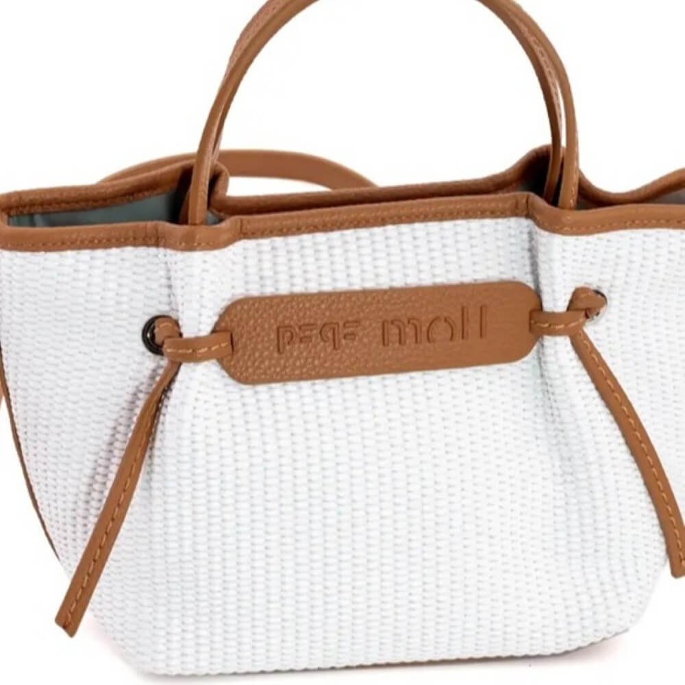 White textured handbag with brown handles and strap on a white background