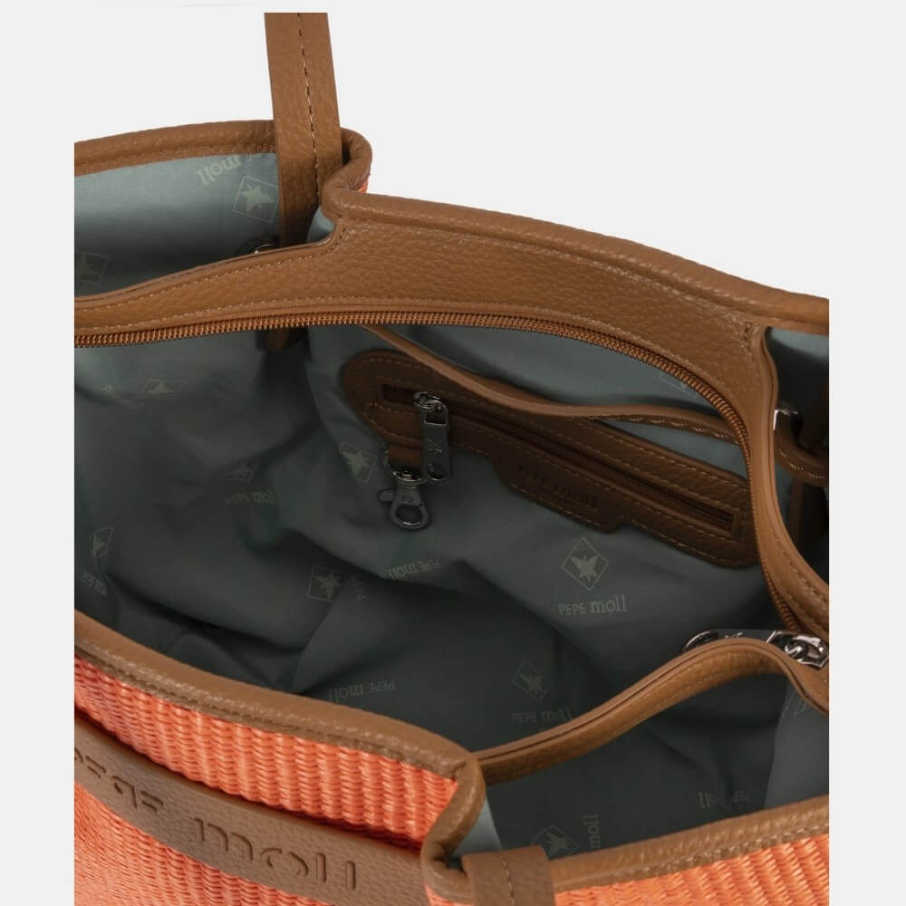 Close-up of a bag with brown and orange handles on a light gray background