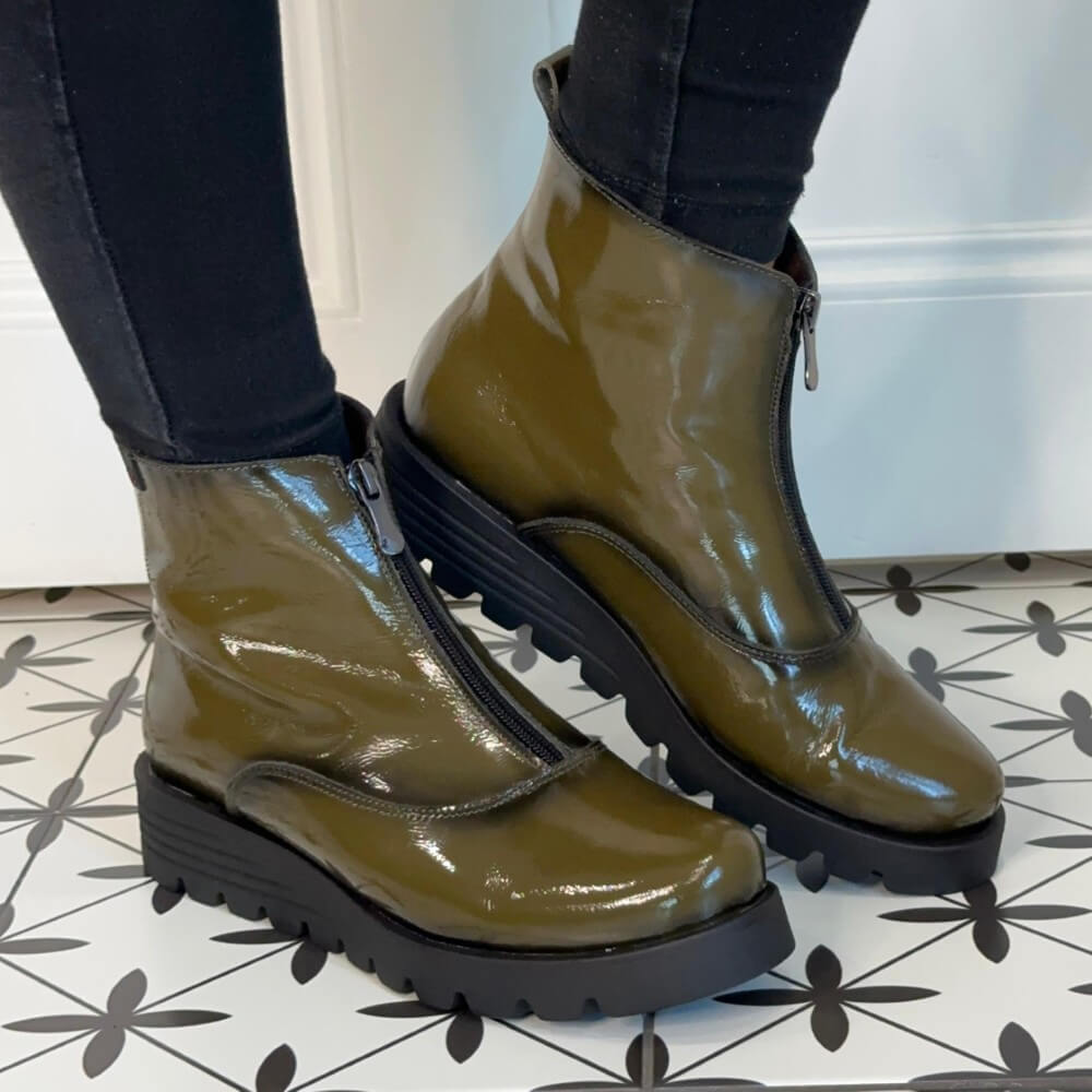 Green patent leather boots worn indoors on a patterned floor. Pepe Saenz Wedge Patent Leather Ankle Boots 21544 Kaki Green