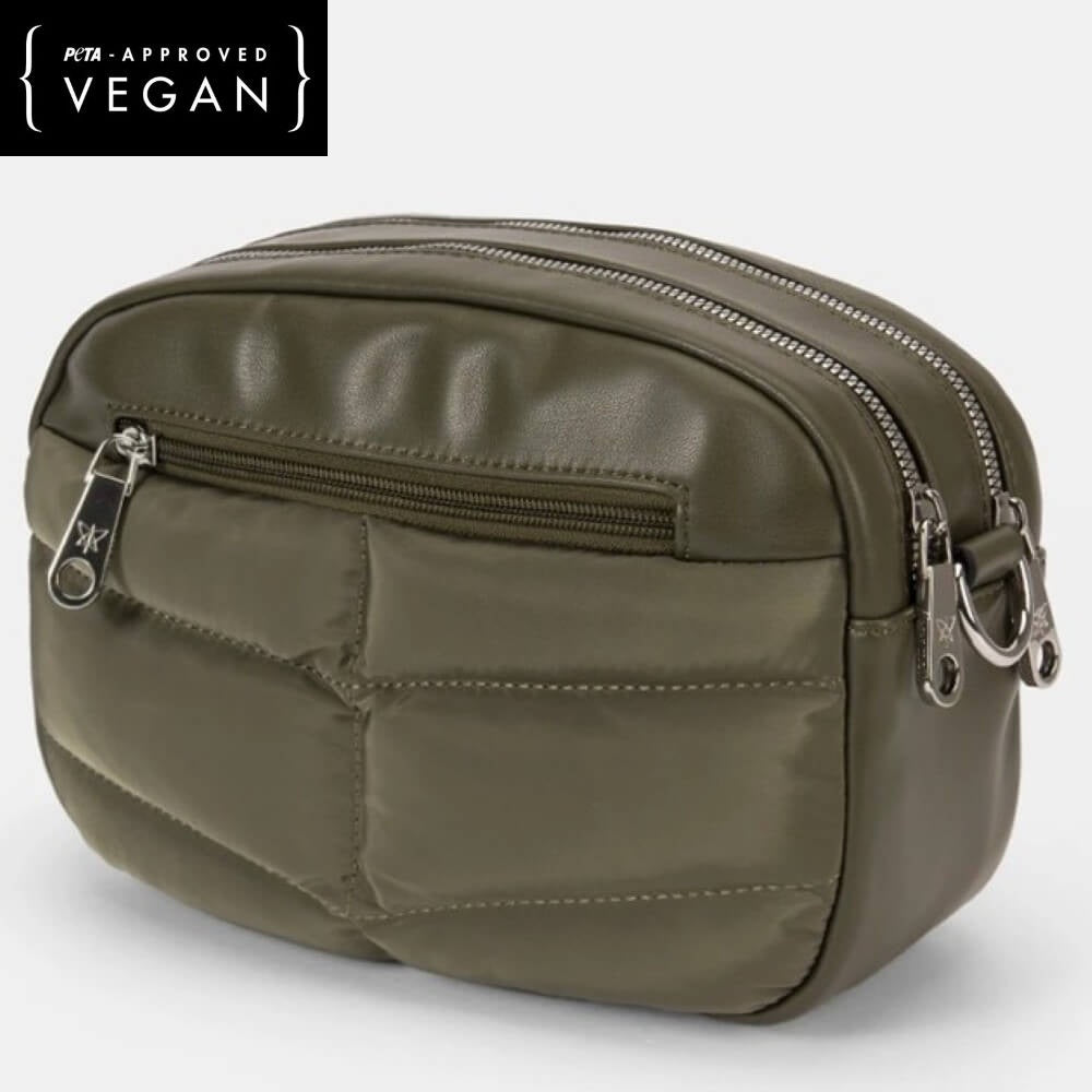 Green vegan leather bag with zippers on a light gray background